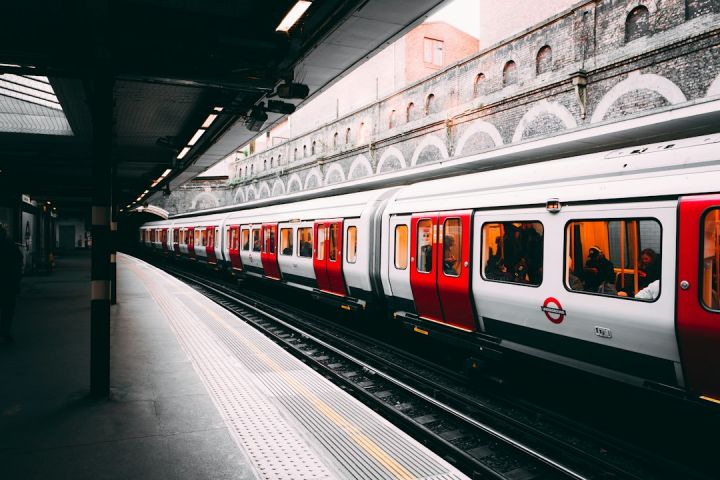 Train - white and red train beside building at daytime