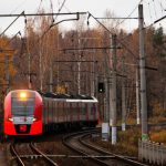 Train - orange train on railroad during daytime