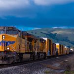 Train - yellow and black train near mountain