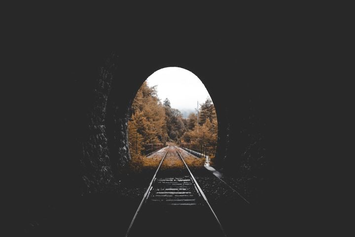 Train - low-light photo of railroad tunnel