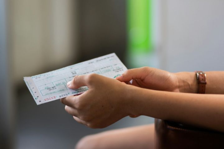 Train Ticket - person holding white printer paper