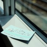 Train Ticket - white printer paper on glass window