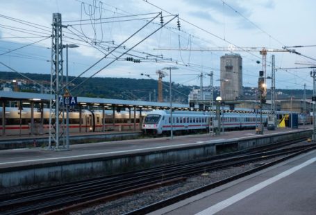 Train Ticket - a train on a train track next to a train station