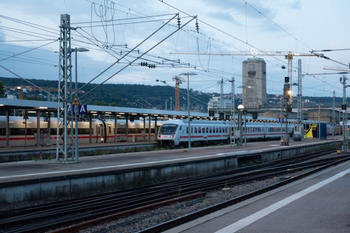 Train Ticket - a train on a train track next to a train station