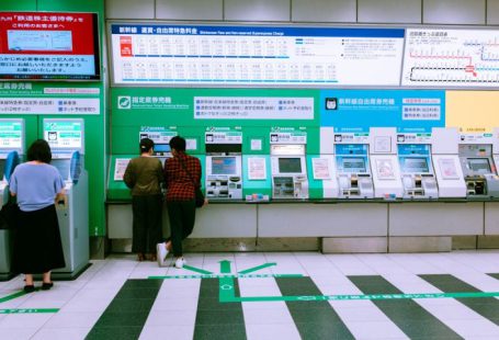 Train Ticket - man in black jacket standing near green and white wall