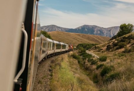 Train Ticket - white train with the distance of mountain during daytime