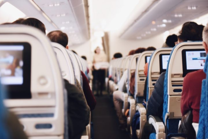 Train Ticket - shallow focus photography of people inside of passenger plane