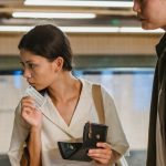 Train Ticket - Focused Asian couple buying ticket on station