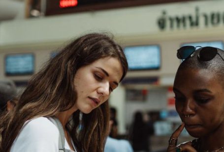 Train Timetables - Women Using a Smartphone on a Train Station