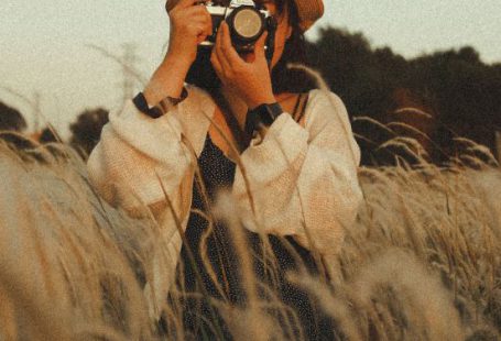 Quiet Zones - Unrecognizable female photographer taking photo on camera in field