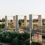 Scenic Train Routes - From above of railway tracks running between lush green plants under cloudless sky