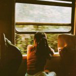 Train Journey - Unrecognizable woman riding train and looking out window