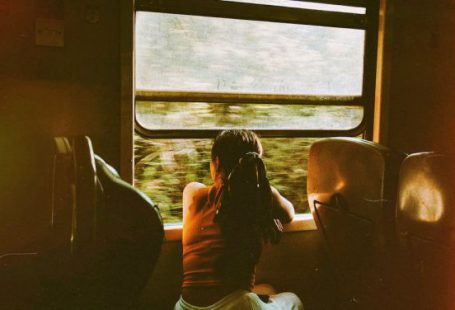 Train Journey - Unrecognizable woman riding train and looking out window