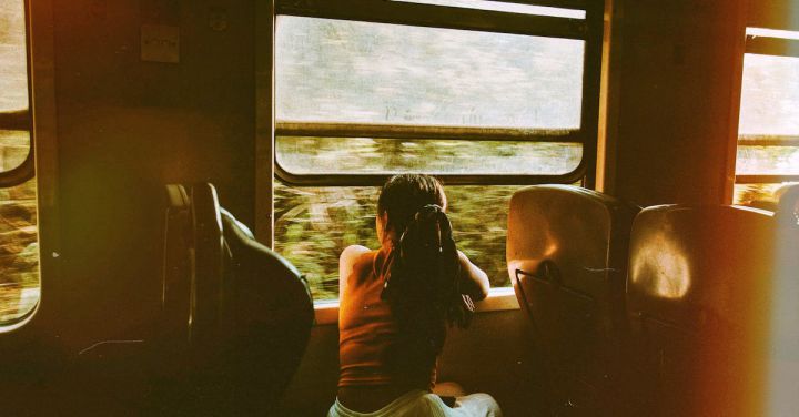 Train Journey - Unrecognizable woman riding train and looking out window
