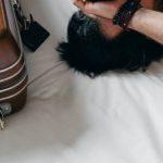 Travel Anxiety - Tired ethnic man lying on bed during relocation in new house