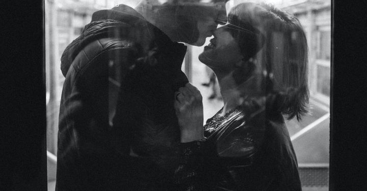 Romantic Train Getaway - Grayscale Photo of Man Kissing Woman's Nose While Standing Inside a Train