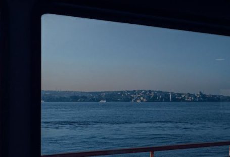 Window Seat - Red and Black Boat on Sea
