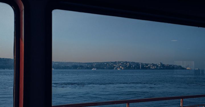 Window Seat - Red and Black Boat on Sea